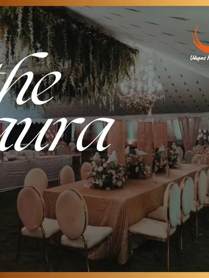 The beautiful aura of one of our catered events, with an elegantly set long table under a canopy of hanging flowers. We are committed to providing delicious food and warm hospitality for a luxury catering experience.