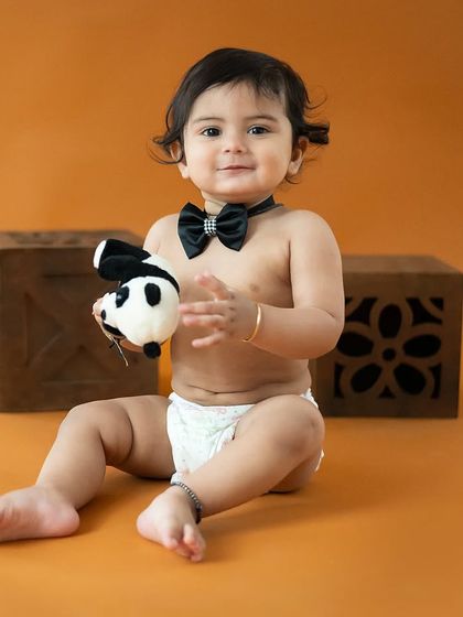 A cute and playful shot with a panda toy. We encourage kids to be themselves and have fun during their session.