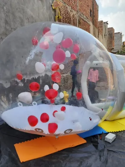 This angle shows the attached inflatable entry tunnel, which keeps the main dome inflated while people go in and out. The entire structure is made from durable, high quality transparent material.