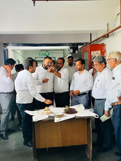 Sharing cake and good wishes. These small celebrations are a big part of our supportive work culture.