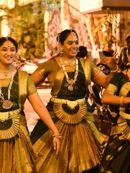 Three of my dancers sharing a candid moment during a Navaratri performance. The joy and camaraderie between my students is what makes our Nrithyakuteera a family.