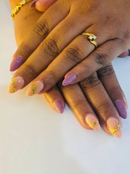 A full view of the beautiful birthday nails, a mix of purple and peach with gold foil.
