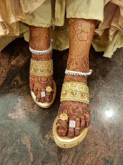 A duplicate of 113, showing the final adorned bridal feet.