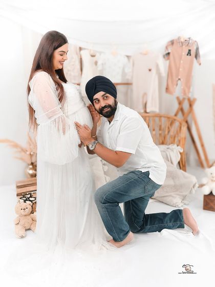 A playful and heartwarming shot of the dad-to-be listening to the baby bump. This image perfectly captures the excitement and anticipation of waiting to meet their little one.