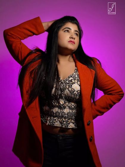 Using colored gel lighting, we created this vibrant portrait with a purple background that makes the red blazer pop even more.