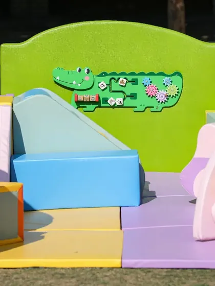 Our play areas feature built-in wall games, like this friendly crocodile puzzle, for extra sensory fun.