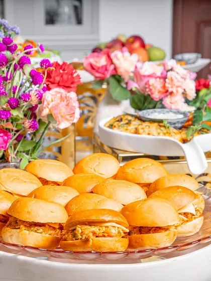 Another look at my popular chicken sliders, beautifully arranged on a glass platter as part of a larger grazing table setup.