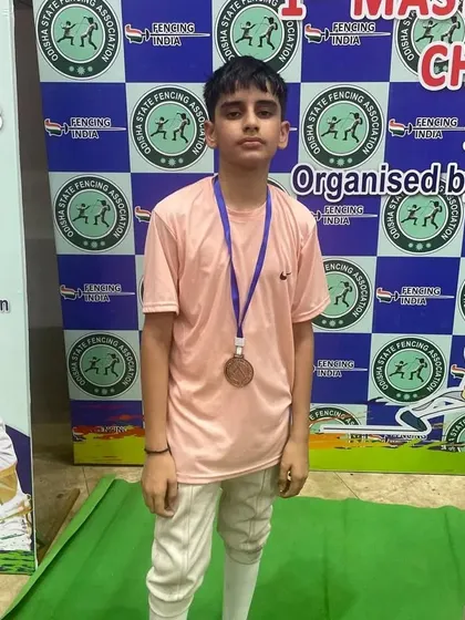 A young fencer from our club with his Bronze medal at a national level championship. We are proud to see our athletes competing with determination and skill.