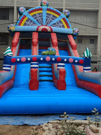 This large dual-lane slide has a unique spider-web arch at the top and a small car detail, showing our custom design capabilities.