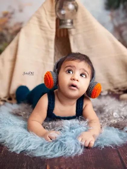 This little rockstar is listening to some tunes in our boho teepee setup. I love combining different themes to create a unique and personalized session for your baby.