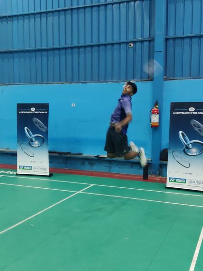 **Testing the New Gear.** An athlete executing a powerful jump smash while testing out a new Yonex racket during the demo day.