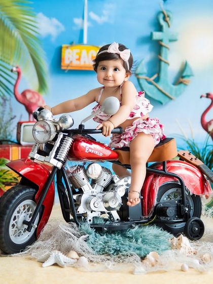 Beach baby on a bike! This fun, summery theme brings the beach to my studio with sand, shells, and a cool red motorcycle.