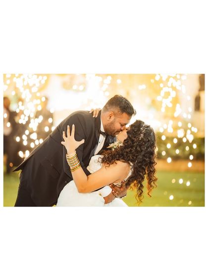 A romantic kiss against a backdrop of dazzling sparklers. This is a perfect, magical shot to capture during the wedding reception.