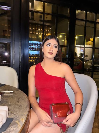A dinner date look at Royal China. A sleek, one-shoulder red dress paired with a red bag.
