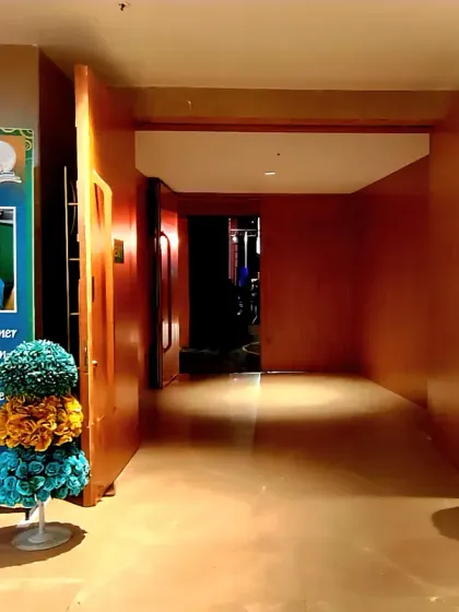 We design every part of the event space, including hallways and entry points. This entrance to the Darshan Academy's annual day celebration features branded standees and floral decor to create a cohesive experience.