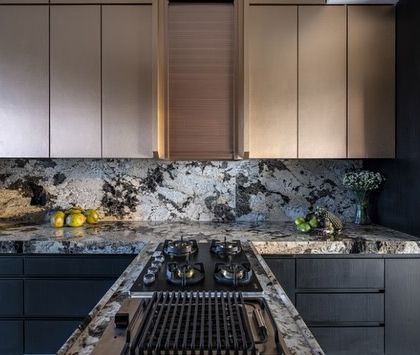 A view of the sleek grill and stovetop in this opulent kitchen. Every detail, from the dramatic marble to the rose gold finish, is designed to make every meal a masterpiece and every gathering a celebration.