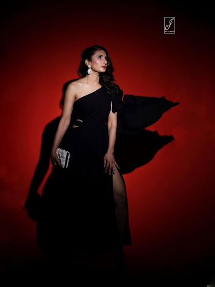 Using dramatic shadows and a single light source, this shot creates a mysterious and high-fashion image, emphasizing the flow of the gown's fabric.