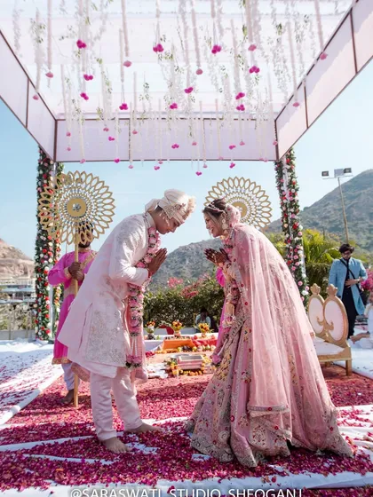 A moment of respect and togetherness. The couple greets each other in a traditional 'namaste' under the mandap after their Varmala ceremony.