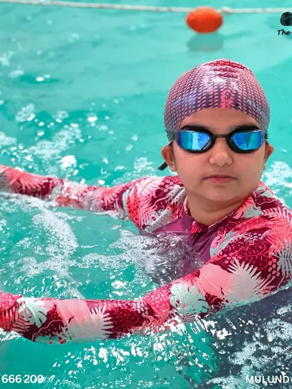 Little swimmers, big adventures. A participant takes a moment to rest between her races at the gala.