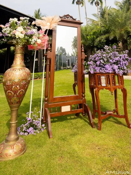 A vintage-style mirror and other antique props add a touch of charm to this outdoor naming ceremony. These details provide beautiful corners for guests to take photos and admire.