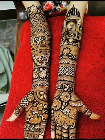 This is the same design as the previous one, showing the complete look. The combination of doli scenes and floral patterns creates a balanced and beautiful bridal mehendi.