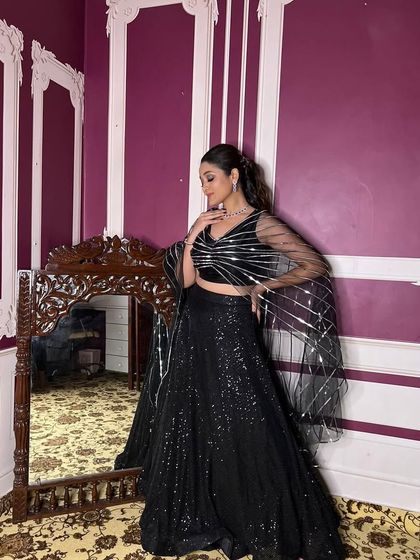 This all-black sequin lehenga is the epitome of cocktail glamour. The shimmering fabric and modern silhouette are perfect for a reception or New Year's Eve party.