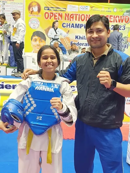 A female student in her sparring gear, ready to compete.
