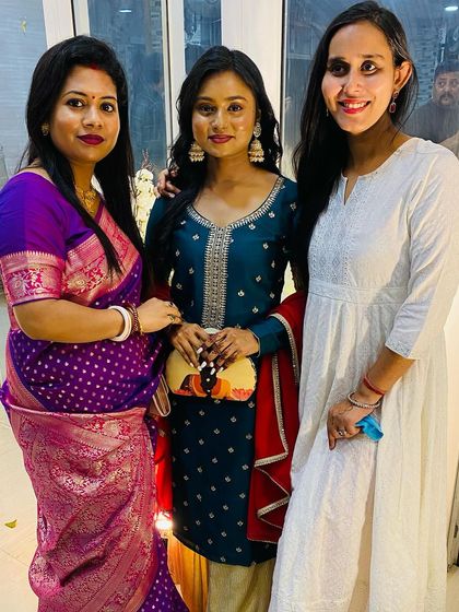 A candid moment with friends. The clutch adds a touch of artistry to this festive and joyful occasion.