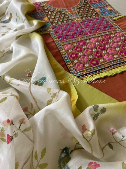 A detailed close-up of the kurta's yoke embroidery, showing the combination of threadwork, sequins, and mirrors, alongside the delicate bird motifs on the dupatta.