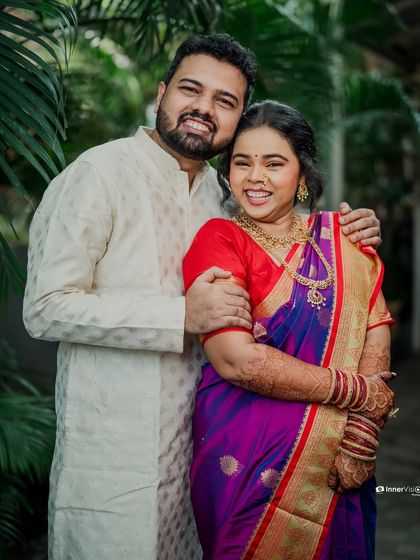 A bright and happy portrait of the couple. Their beaming smiles and comfortable embrace reflect the joy and excitement of their engagement.