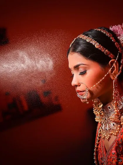A candid shot from the getting-ready session, as the makeup artist applies the finishing touches. Capturing these behind the scenes moments is part of telling the complete story of your wedding day, from the quiet anticipation to the final celebration.