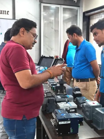 A close-up of a product demonstration during our Retailer Day in Pune. Our experts explain the features of our various energy management devices to an engaged audience.