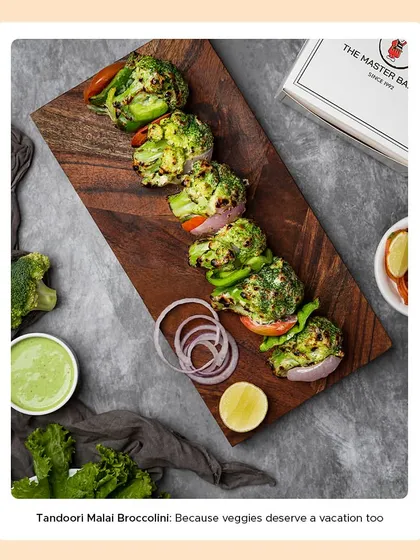 A serving of our Tandoori Malai Broccoli skewers, showcasing the creamy coating and light char from the tandoor. It's a luxurious vegetarian starter that's always a crowd-pleaser.