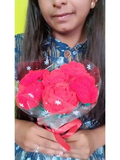 A closer look at the wrapped red rose bouquet.