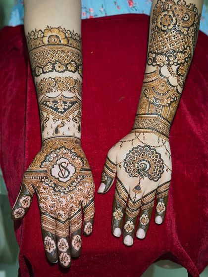 A classic engagement design featuring the couple's initials in a beautiful monogram on one hand, and a symbolic peacock on the other.