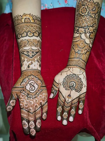 A classic engagement design featuring the couple's initials in a beautiful monogram on one hand, and a symbolic peacock on the other.