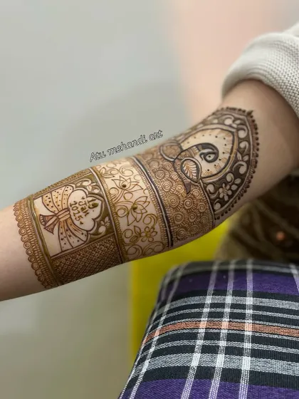 A side view of the arm, showing the custom date design and a peacock motif.