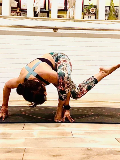 A challenging balancing twist that requires core strength and flexibility. This pose is a reminder that your body is your most priceless possession, and it's important to prioritize your health, especially during festive seasons.