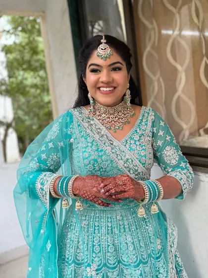 A dreamy, ethereal look for a Sangeet or reception. The soft shimmer on the eyes and subtle lip colour complement her stunning turquoise lehenga.