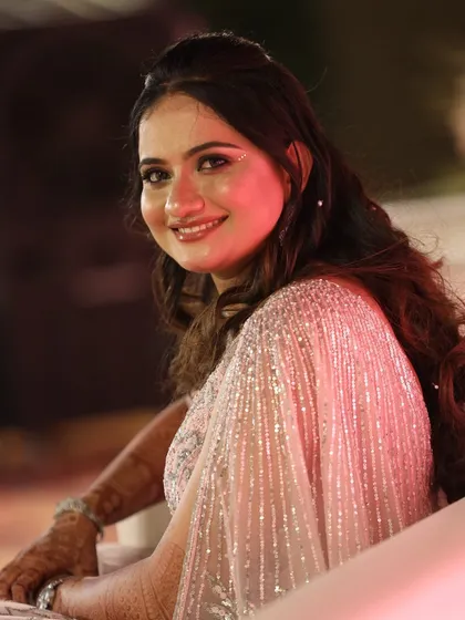 A happy and relaxed bride enjoying her reception. The makeup is polished and sophisticated, perfect for the final event of the wedding celebrations.