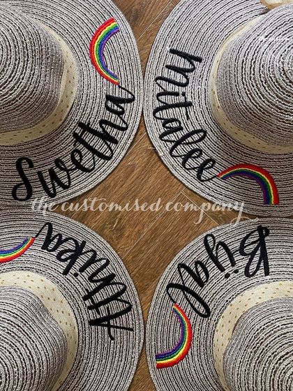 Stay stylish and sun-safe on your holiday getaway. These chic sun hats feature personalized names and a cute rainbow patch, adding a touch of color and fun to your beach look.