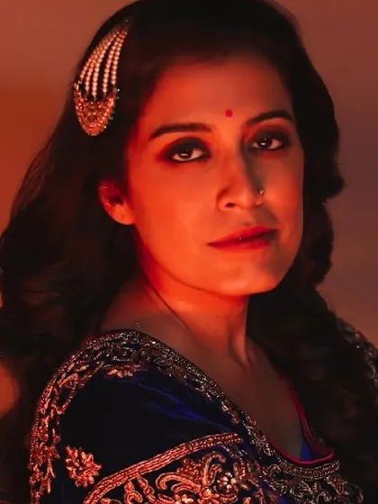 A close-up from the same birthday shoot, with warm, dramatic lighting. Her expression is confident and serene.