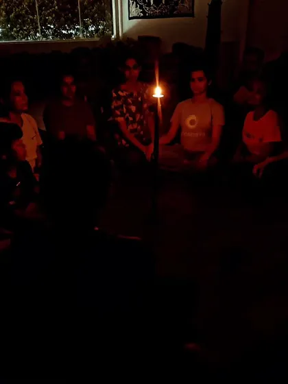 Students practicing Tratak (candle gazing) meditation. This purification technique strengthens the eye muscles, improves concentration and memory, and is very effective for those who have difficulty sleeping.