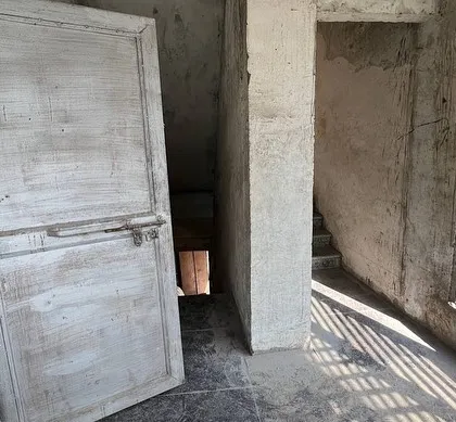 The state of the interior before our intervention, showing the raw, unfinished spaces we had to work with.