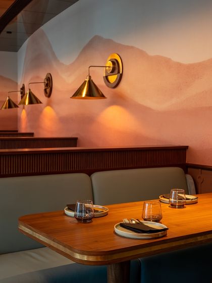 The details make the difference. Our wall murals and custom brass light fixtures add a layer of artistry to the dining experience, providing a beautiful and unique backdrop for your event photos.