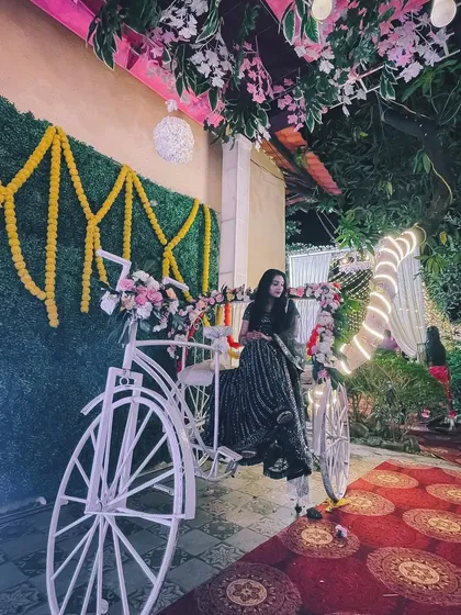 My partner posing with a decorative bicycle at a wedding. It's always a joy to see and capture the fun details at events.