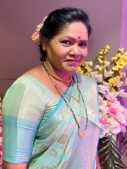 A close-up of the bride's mother, her makeup looking fresh and natural.