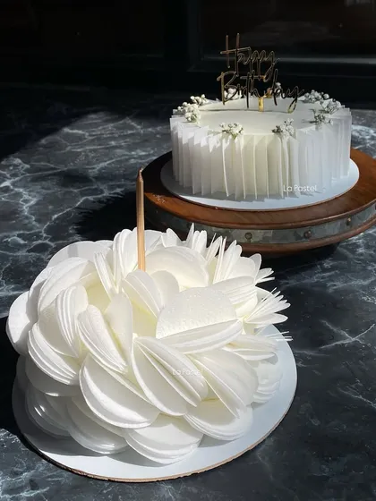 Two of my favorite white cakes together. One features the complex wafer paper bloom, while the other showcases the elegant pleated design.