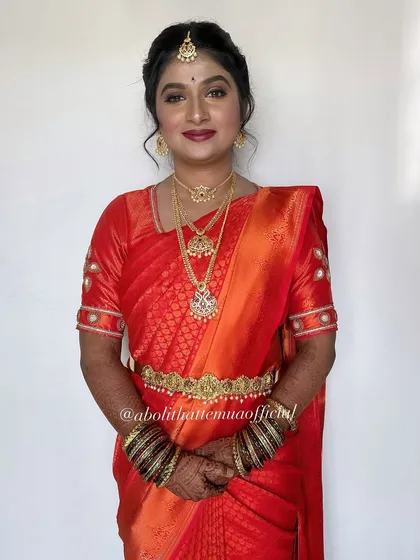 I absolutely adore the richness of South Indian bridal traditions. Here, I've created a classic look with bold lips and radiant skin to complement the vibrant Kanjeevaram saree and temple jewelry.