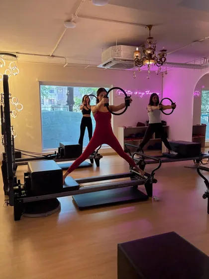 Using the magic circle while in a wide-legged stance on the reformer targets the arms and inner thighs simultaneously. It's all about that multi-tasking burn.
